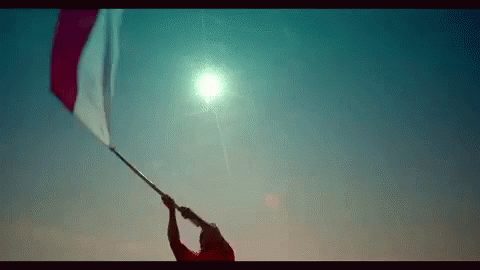 Man Holding Red and White Flag
