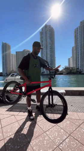 Man Holding Red BMX Bike