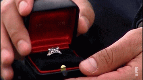Man Holding Red Box With Diamond Ring