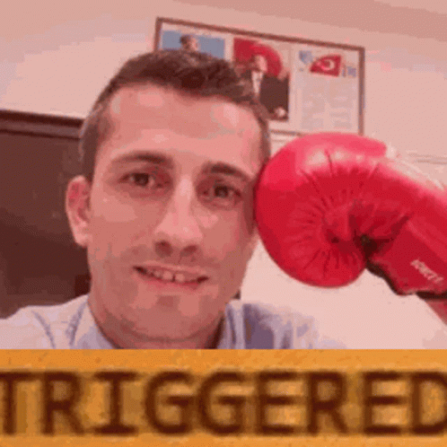 Man Holding Red Boxing Glove to Forehead