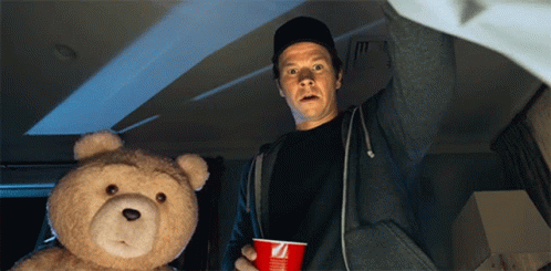 Man Holding Red Cup With Letter Z Next To Teddy Bear GIF