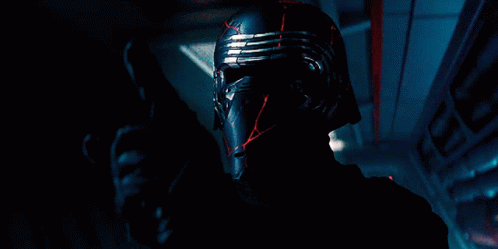 Man Holding Red Lightsaber With AT-ATs GIF