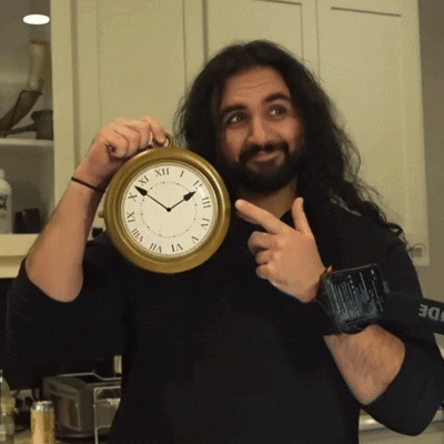 Man Holding Roman Numeral Clock