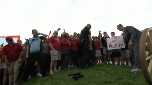 Man Holding Sign Saying Colones Are Purry