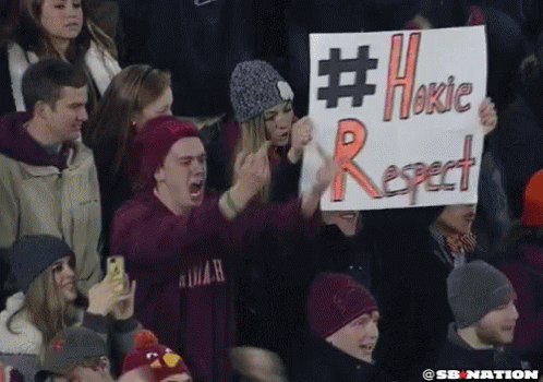 Man Holding Sign Saying #Hokie Respect