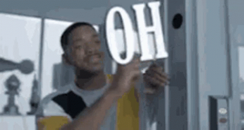 Man Holding Sign Saying Oh On Wall GIF