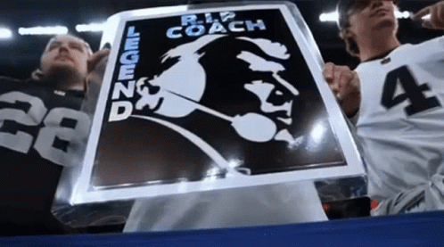 Man Holding Sign Saying Rip Coach Legend GIF