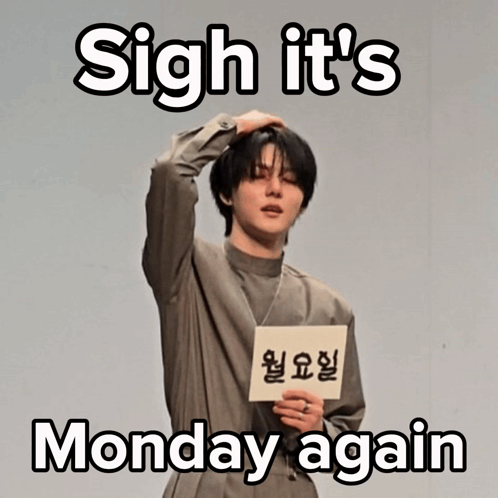 Man Holding Sign Saying Sigh It's Monday Again