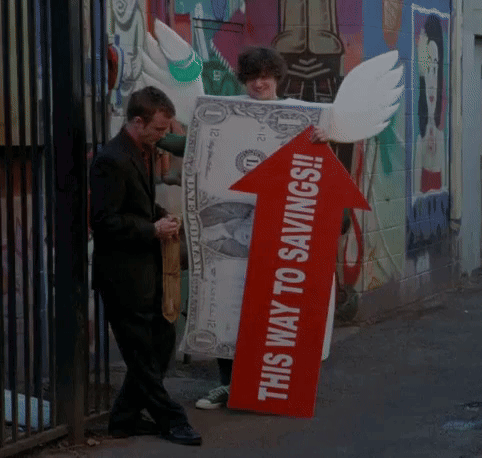 Man Holding Sign Saying This Way to Savings