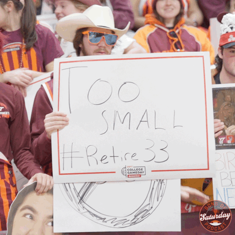 Man Holding Sign Saying Too Small Retire 33