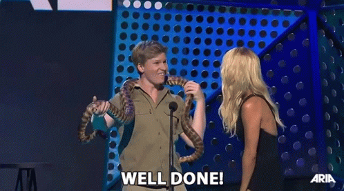 Man Holding Snake Woman Saying Well Done