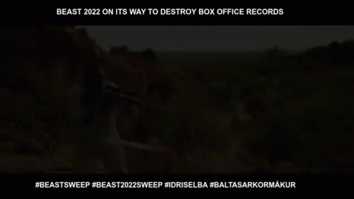 Man Holding Sniper Rifle in Desert