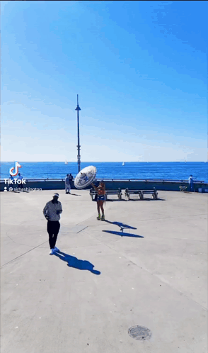 Man Holding Sombrero and Woman Rollerblading