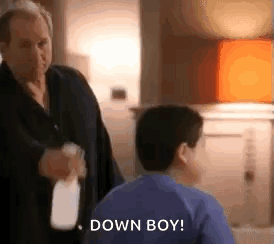Man Holding Spray Bottle Next to Boy