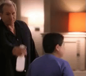 Man Holding Spray Bottle Talking To Boy GIF