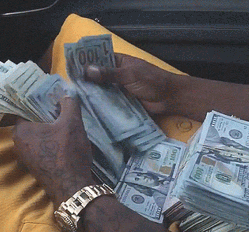 Man Holding Stack of 100 Dollar Bills