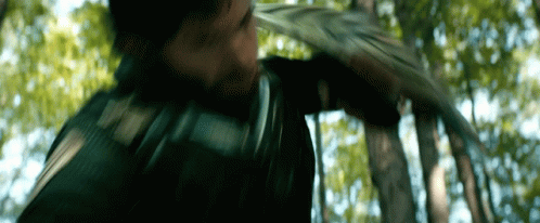 Man Holding Sword in Woods