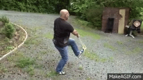 Man Holding Sword On Dirt Road GIF