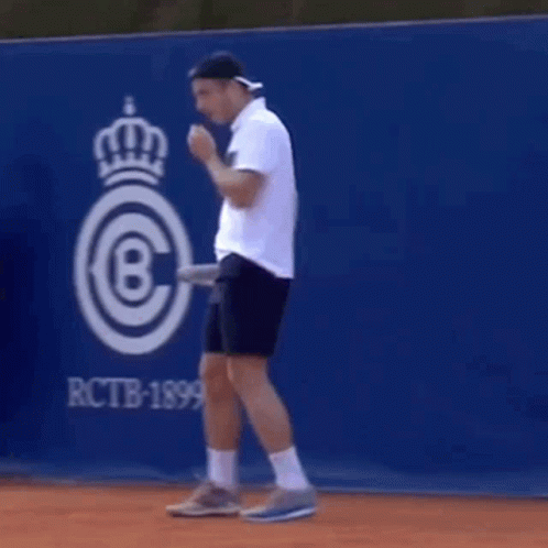 Man Holding Tennis Racket on Tennis Court