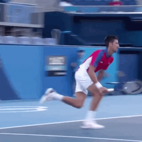 Man Holding Tennis Racquet Another Throwing Ball