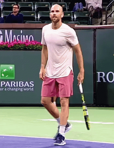 Man Holding Tennis Racquet by Pariba Advertisement