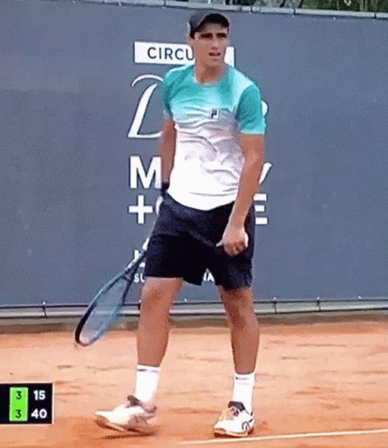 Man Holding Tennis Racquet in Front of Circul Sign