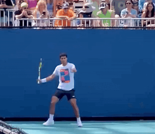 Man Holding Tennis Racquet In Front Of Crowd GIF