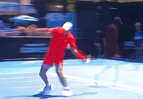 Man Holding Tennis Racquet in Front of Emirates Ad
