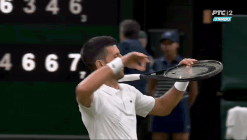 Man Holding Tennis Racquet Near PTC Scoreboard