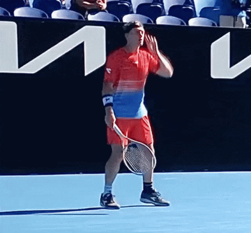 Man Holding Tennis Racquet on Blue Court