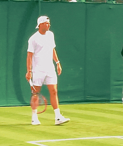 Man Holding Tennis Racquet on Court
