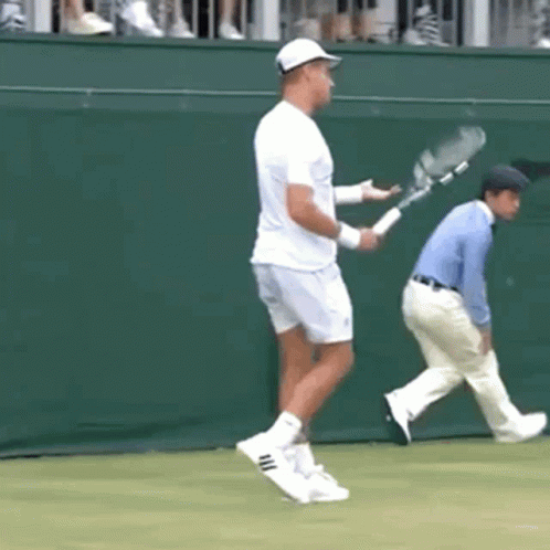 Man Holding Tennis Racquet on Court