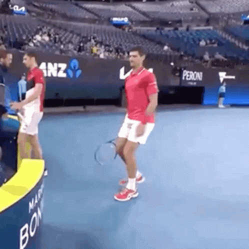Man Holding Tennis Racquet on Tennis Court