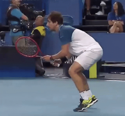 Man Holding Tennis Racquet Woman in Stands