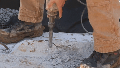 Man Holding The Head Of A Jackhammer GIF
