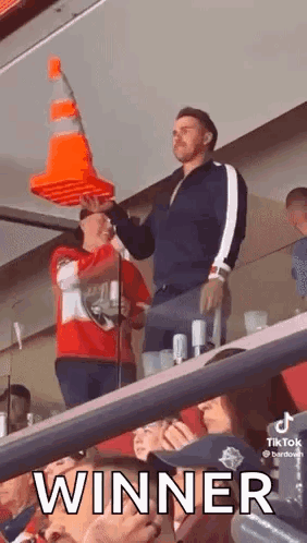 Man Holding Traffic Cone on Head