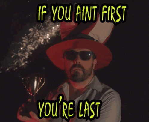 Man Holding Trophy If You Ain't First You Last