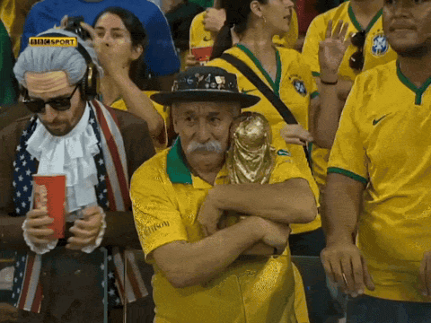 Man Holding Trophy In Crowd With BBC Sport Logo GIF