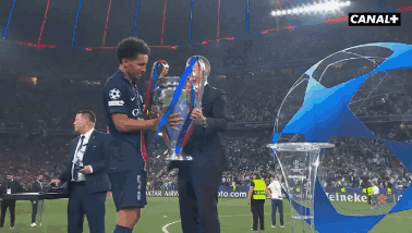 Man Holding Trophy In Front Of Canal Sign GIF