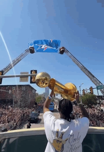 Man Holding Trophy In Front Of Crowd GIF