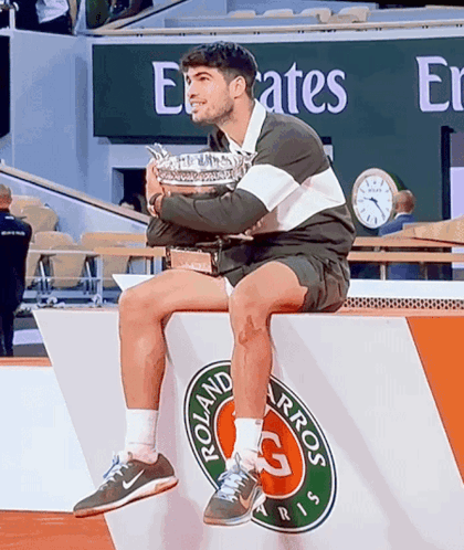 Man Holding Trophy On Podium Emirates Sign GIF