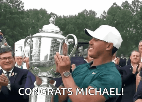 Man Holding Trophy With Congrats Michael