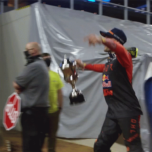 Man Holding Trophy With Red Bull Shirt