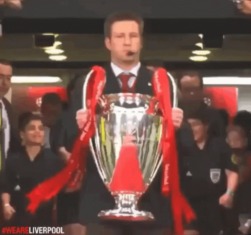Man Holding Trophy with We Are Liverpool