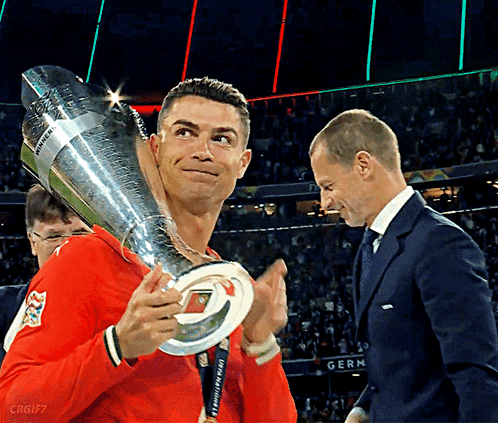 Man Holding UEFA Champions League Trophy GIF