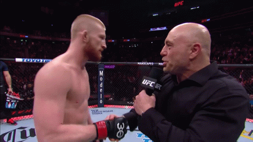 Man Holding UFC Microphone Talks To Another Man GIF