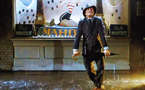 Man Holding Umbrella in Rain at Mahout Store