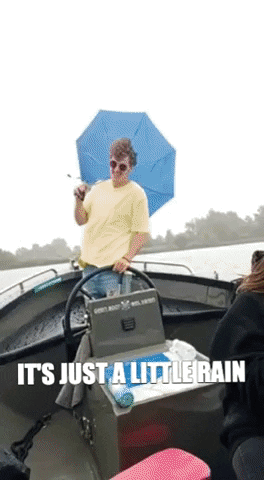 Man Holding Umbrella On Boat Saying It's Just A Little Rain GIF