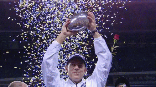 Man Holding Up Champions Trophy