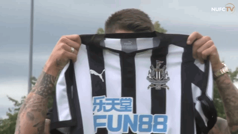 Man Holding Up Shirt Saying Fun88